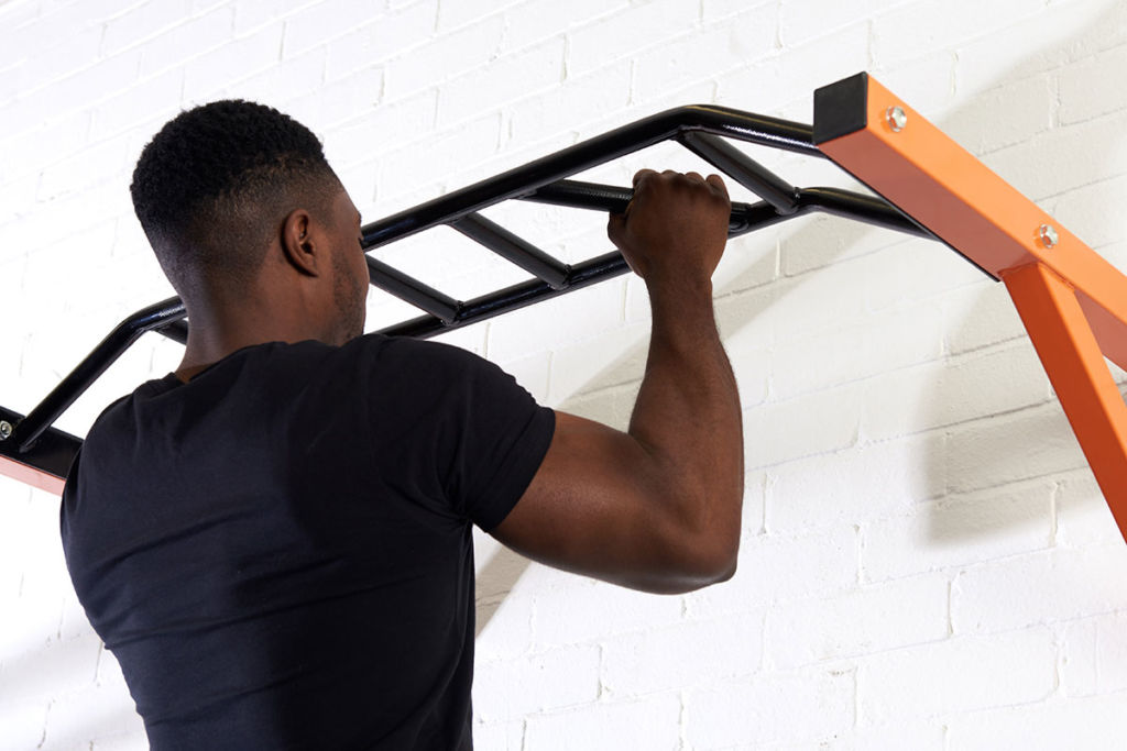 mirafit fitness expert does a pull up on a multi grip bar